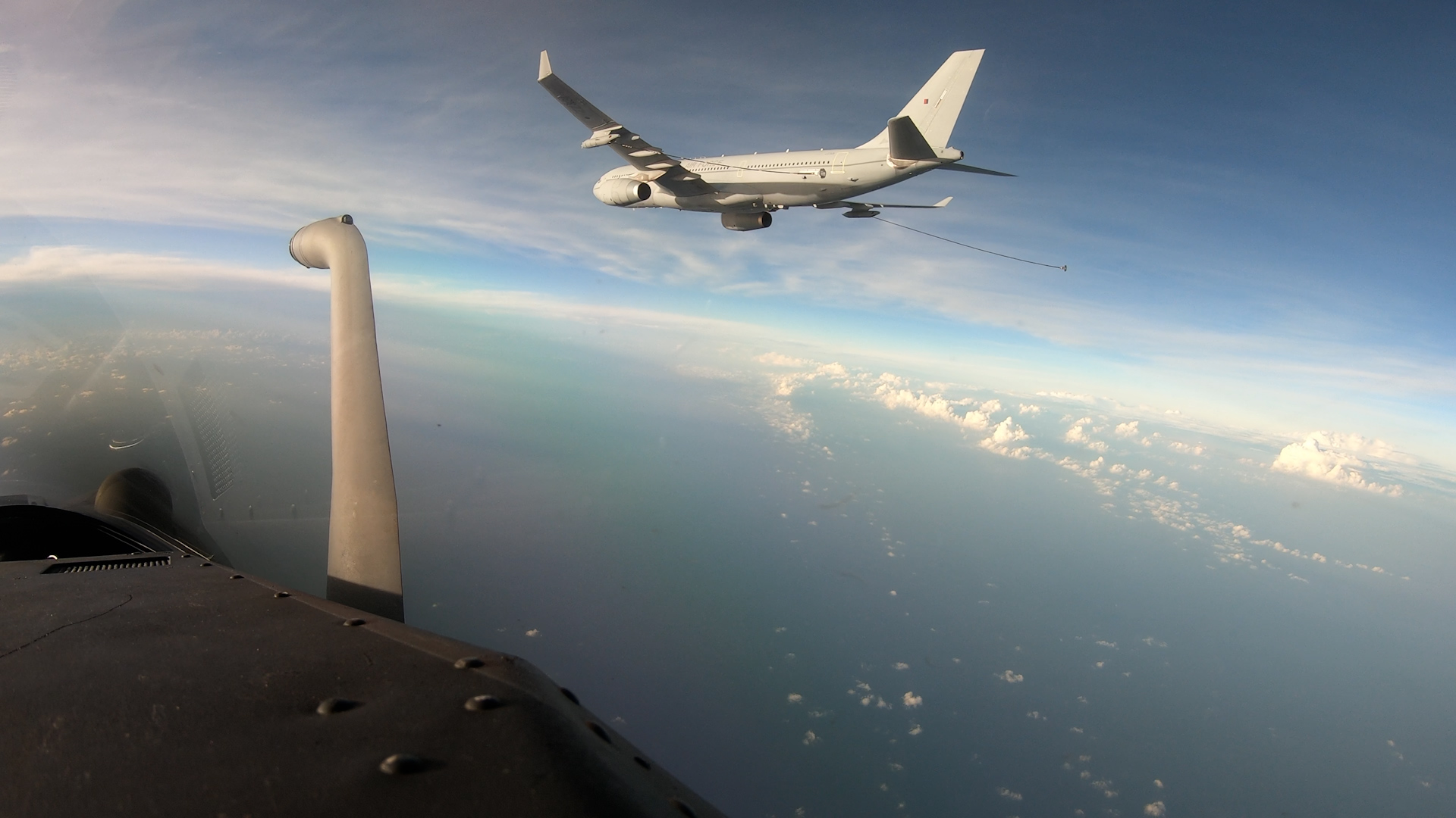 Image shows RAF Voyager in flight over clouds.